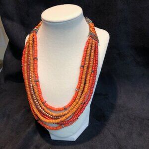 Chico's necklace - numerous strands of orange beads.